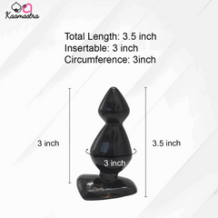 Black silicone butt plug with measurements on a white background