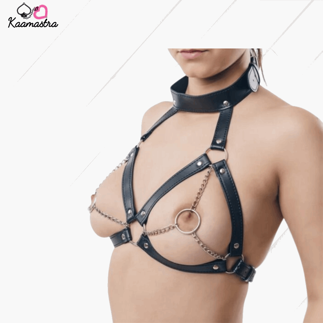 Black leather harness with chain details on a model against a white background, featuring the brand 'Kaamastra'.