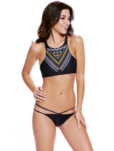 A woman wearing a black bikini with a boho print design, featuring a high neck and strappy details.