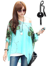 A woman wearing a vibrant green kaftan with geometric patterns, paired with sunglasses and holding a mobile phone.