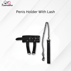 Black penis holder with chain and lash on a white background, branded 'Kaamastra'.