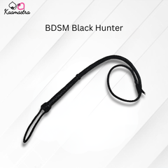 Black leather whip labeled 'BDSM Black Hunter' on a white background with 'Kaamastra' branding.