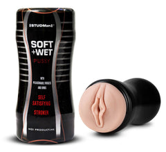 The image shows a product packaging and a handheld masturbator. The packaging is black with the product name "STUDMan Sof+Wet Pussy" and the feature of being a self-satisfying stroker.