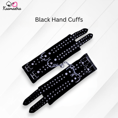 Black hand cuffs with rhinestones on a white background, branded 'Kaamastra'.