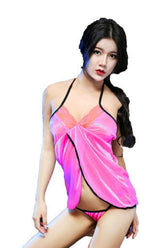 A model wearing a dark pink, silky, v-neck babydoll with elasticated straps and a plunge back design.