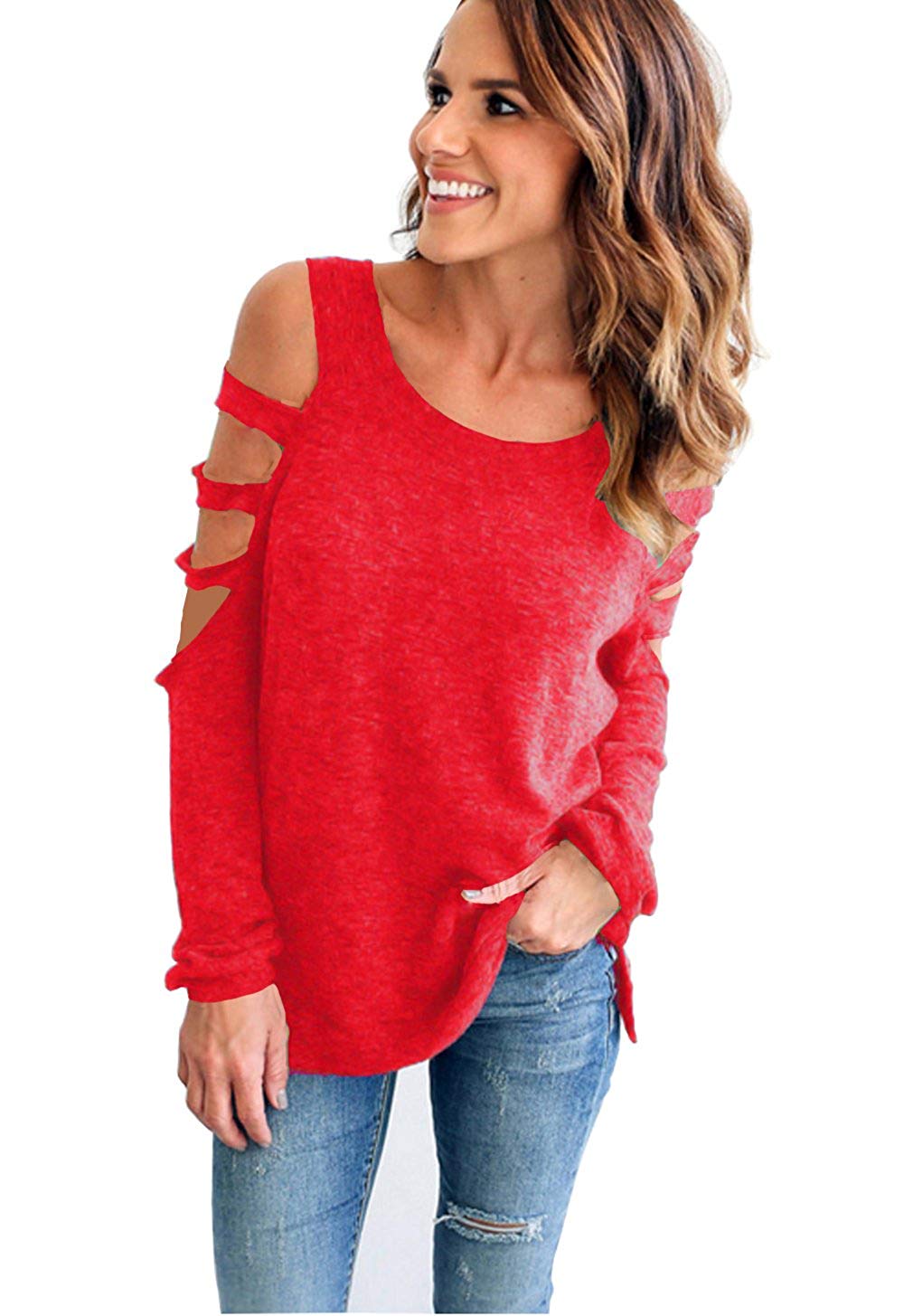 A woman wearing a red cold shoulder top with long sleeves, paired with blue ripped jeans.