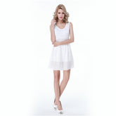 A fashionable V-neck and sleeveless white dress with a translucent pattern, showcasing slender legs.