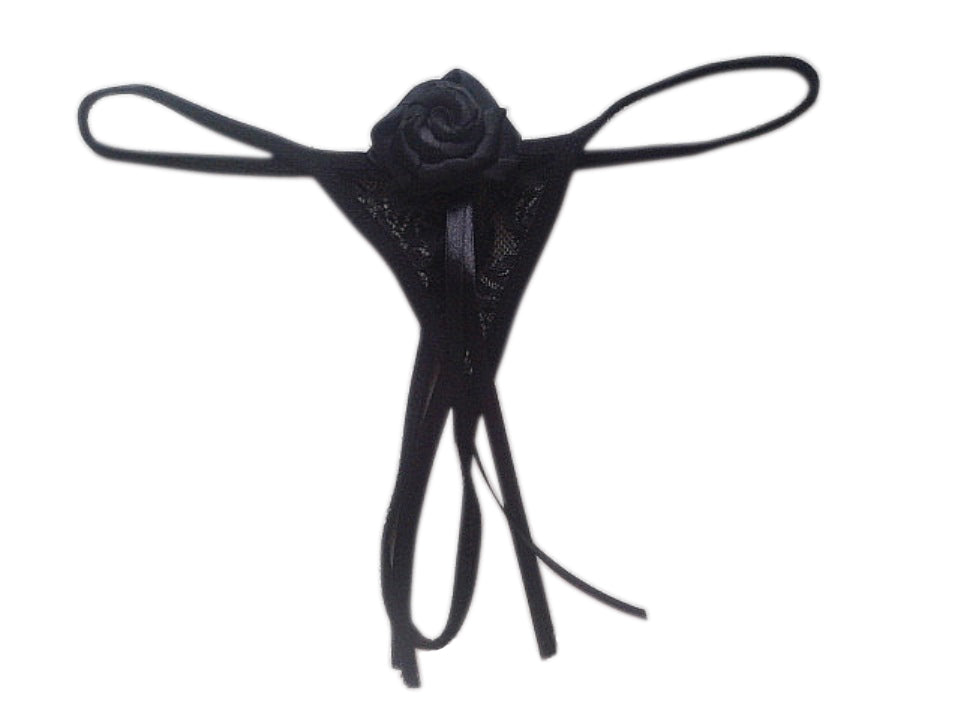 A black ribbon thong with a floral design and a bow detail in the center, against a white background.