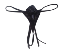 A black ribbon thong with a floral design and a bow detail in the center, against a white background.