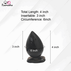 Black drop-shaped object with measurements on a white background