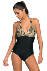 A model wearing a Kaamastra Black Camouflage Print Monokini Swimsuit with a halter neck tie.