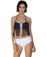 Woman wearing a navy bikini top with fringe and white bottoms