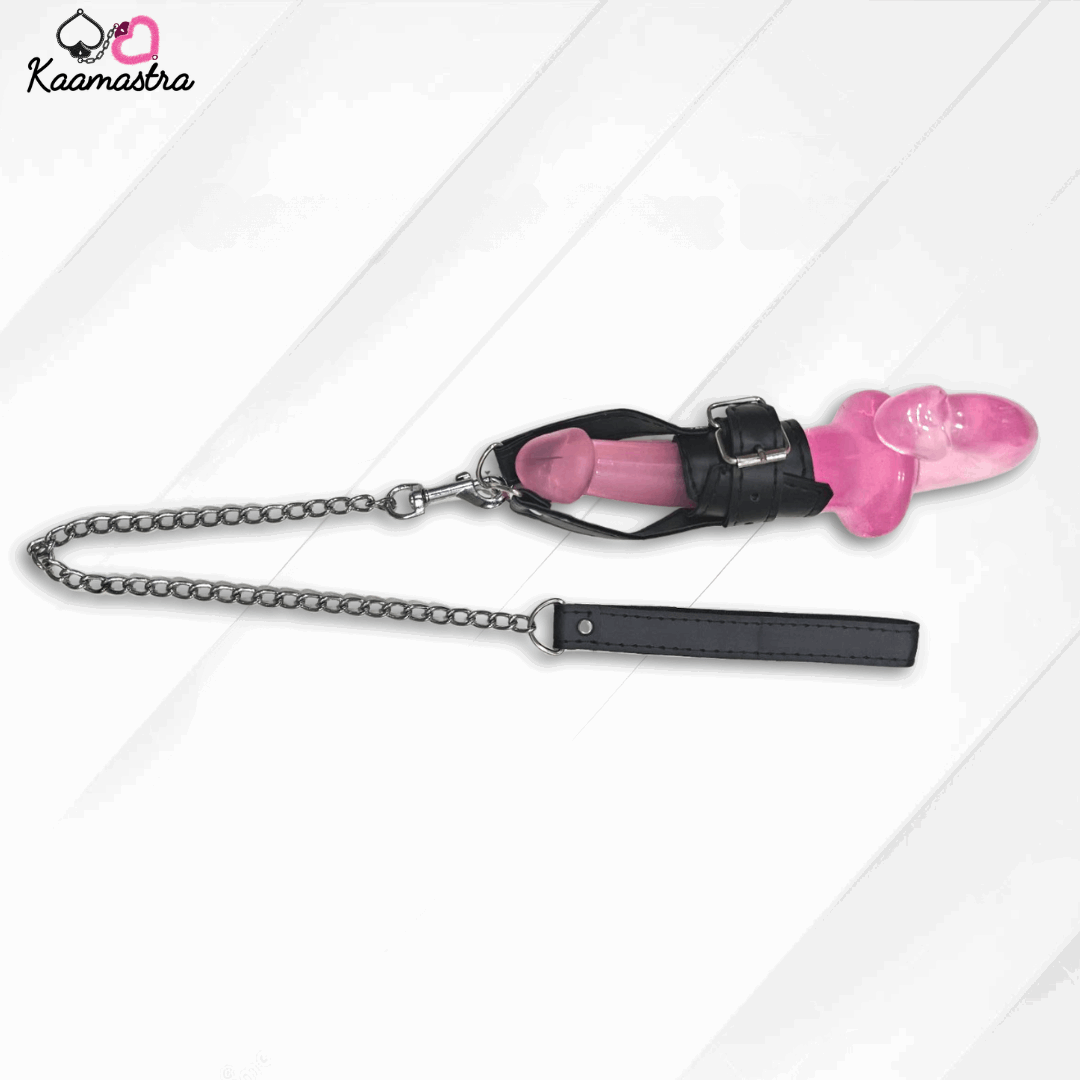 Pink chastity device with black chain and leather strap on a white background, branded 'Kaamastra'.
