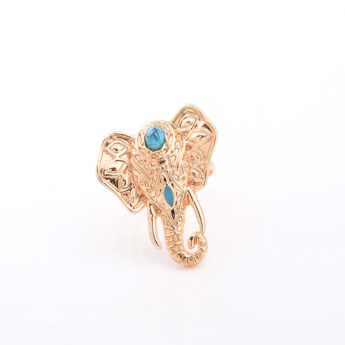 A vintage-style golden elephant ring with a blue stone on top.