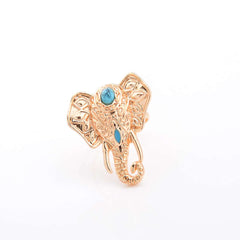 A vintage-style golden elephant ring with a blue stone on top.