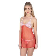 A woman modeling a see-through black lace top with white lace and a spaghetti halter neck, paired with a red G-string.