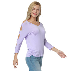 A woman wearing a purple V-neck top with full sleeves and a cutout detail on the front.