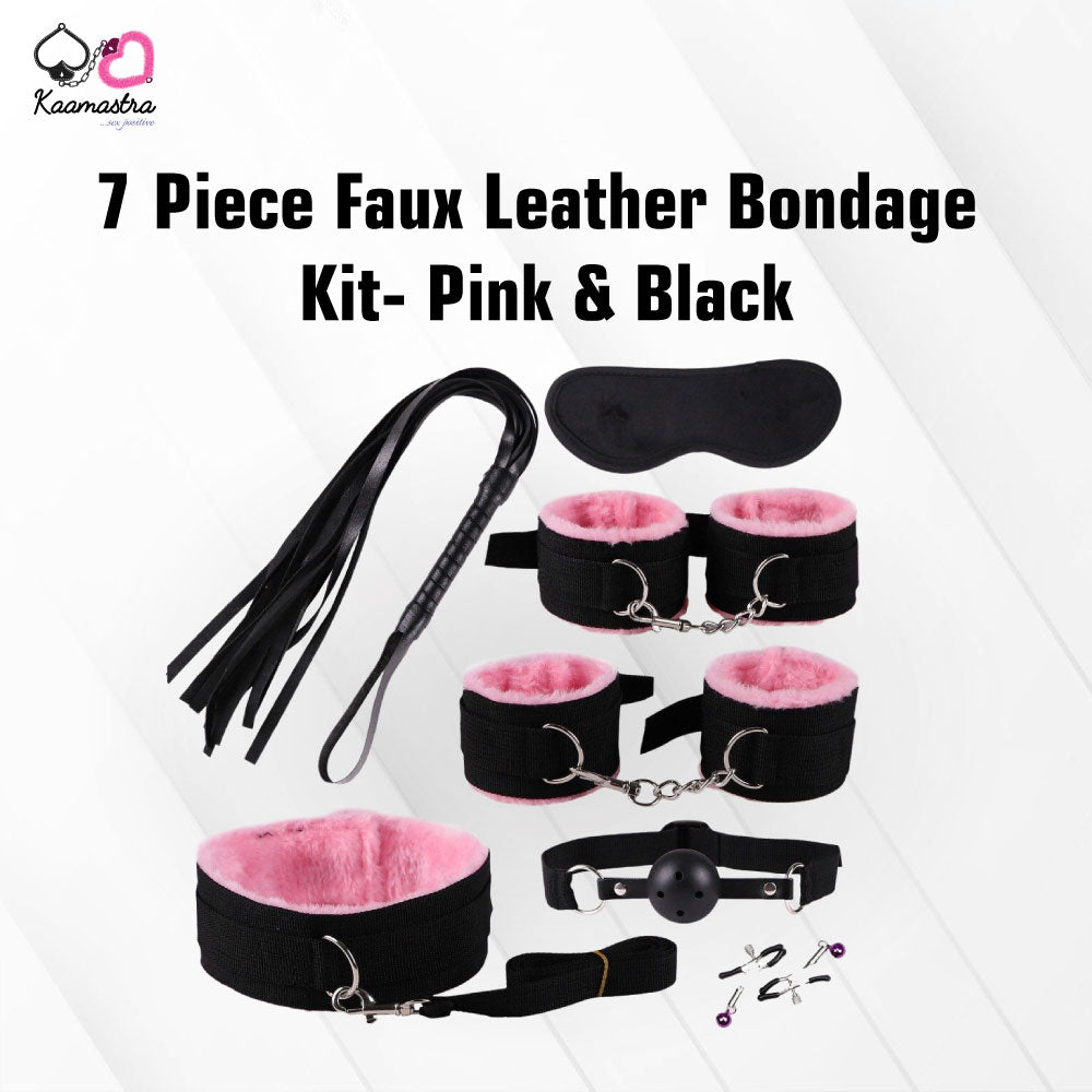 The image showcases a 7-piece faux leather bondage kit in pink and black, including wrist handcuffs, ankle cuffs, nipple clamps, a whip, a mouth ball gag, a blindfold, and a collar with a leash.